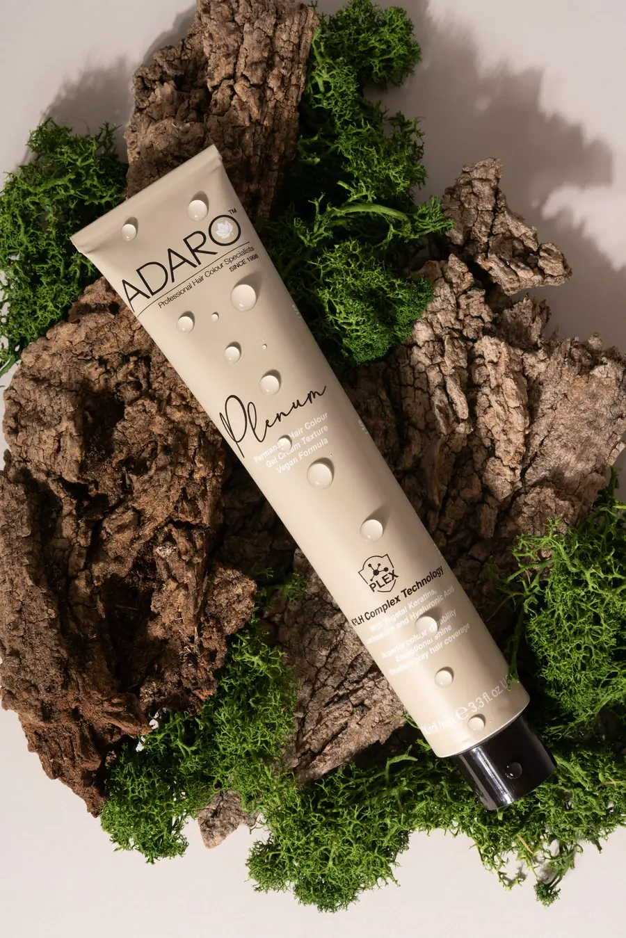 Adaró Plenum tube resting on bark and moss with water drops